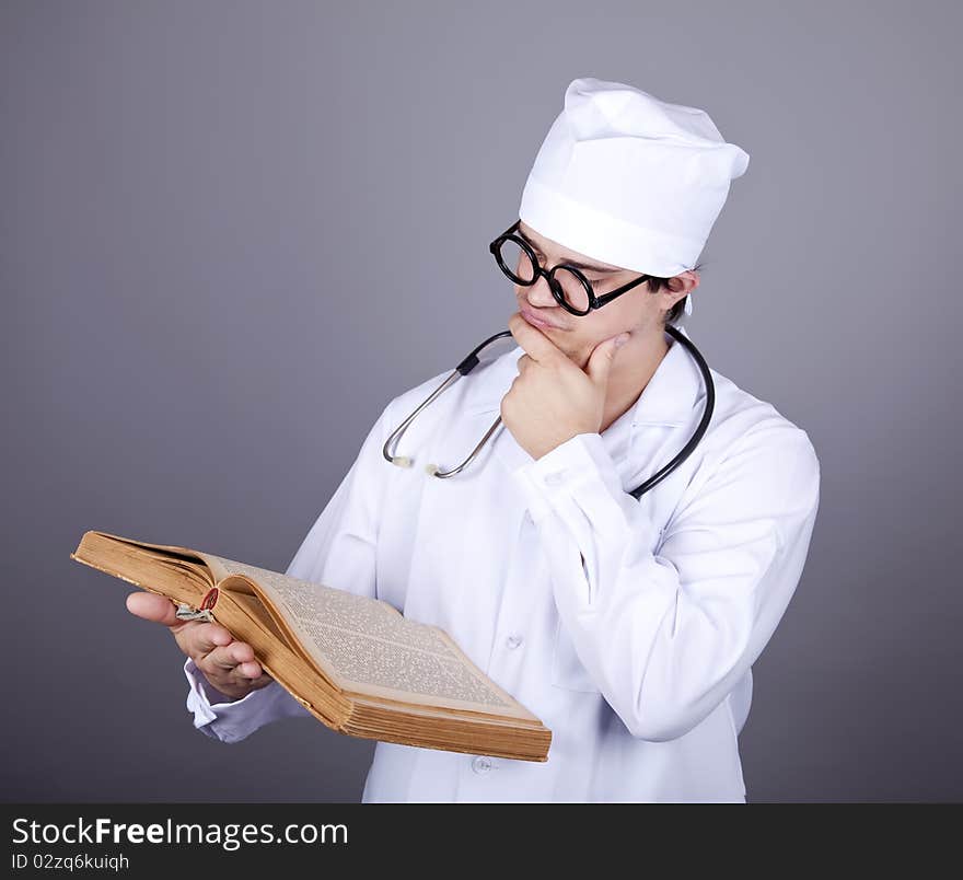 Young doctor with book. Studio shot.