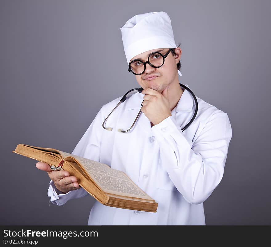 Young doctor with book. Studio shot.