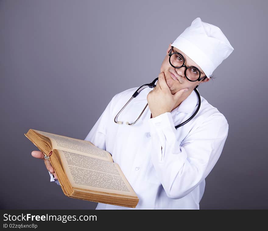 Young doctor with book. Studio shot.