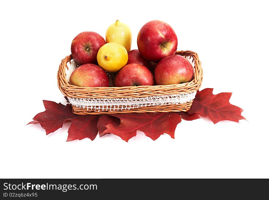 Wooden basket full of autumn apples and lemons isolated on a white background. Wooden basket full of autumn apples and lemons isolated on a white background.