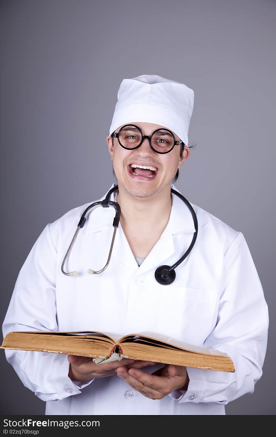 Young doctor with book. Studio shot.