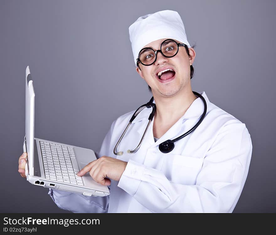 Young doctor with notebook. Studio shot.