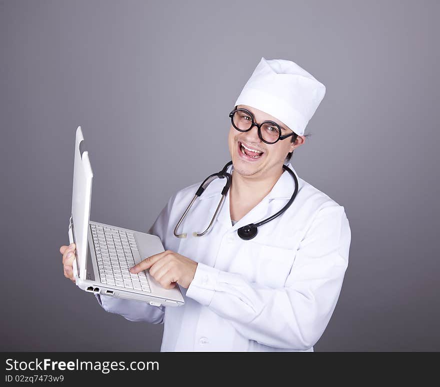 Young doctor with notebook. Studio shot.