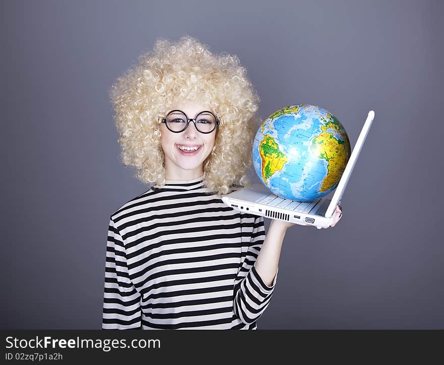 Funny girl in glasses keeping notebook and globe. Studio shot.