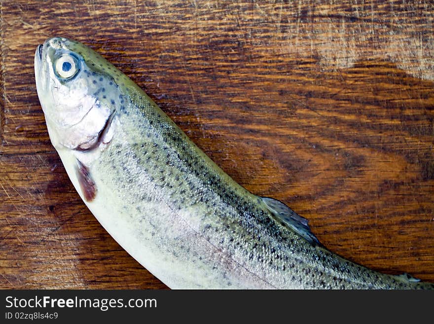 Preparing rainbow trout on wooden plate. Preparing rainbow trout on wooden plate