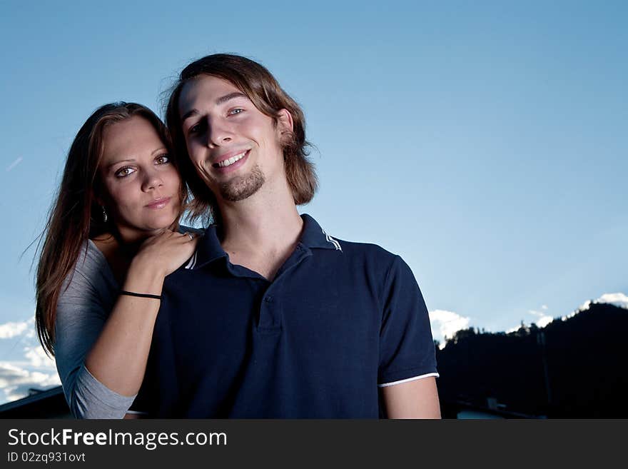 Young couple in love with blue sky in the background. Young couple in love with blue sky in the background