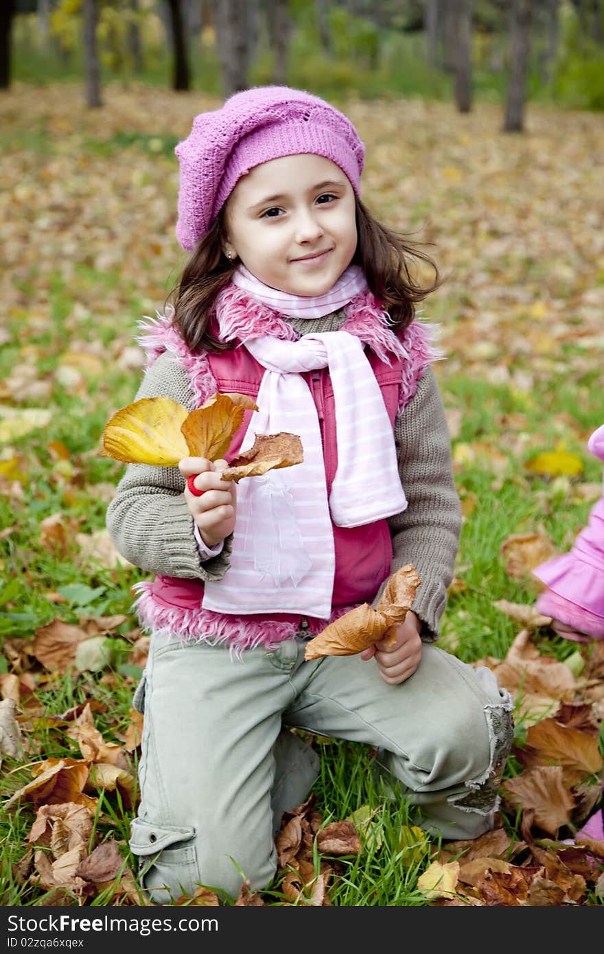 Cute girl in autumn park. Portrait shot.