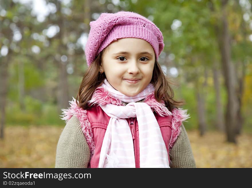 Cute girl in autumn park. Portrait shot.