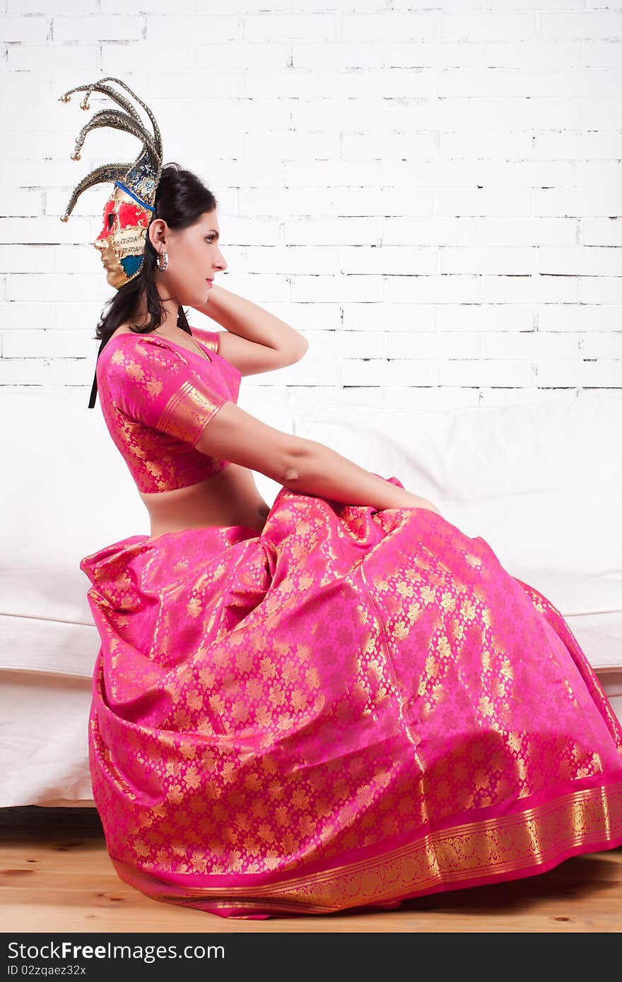 Glamorous portrait of a beautiful young woman in a sari dress (Dark Key)