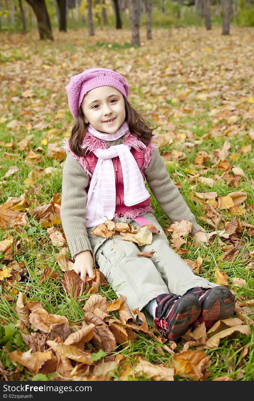 Cute girl in autumn park. Portrait shot.