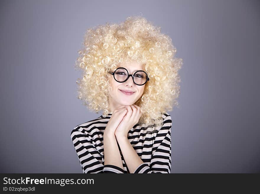 Portrait of funny girl in blonde wig. Studio shot.