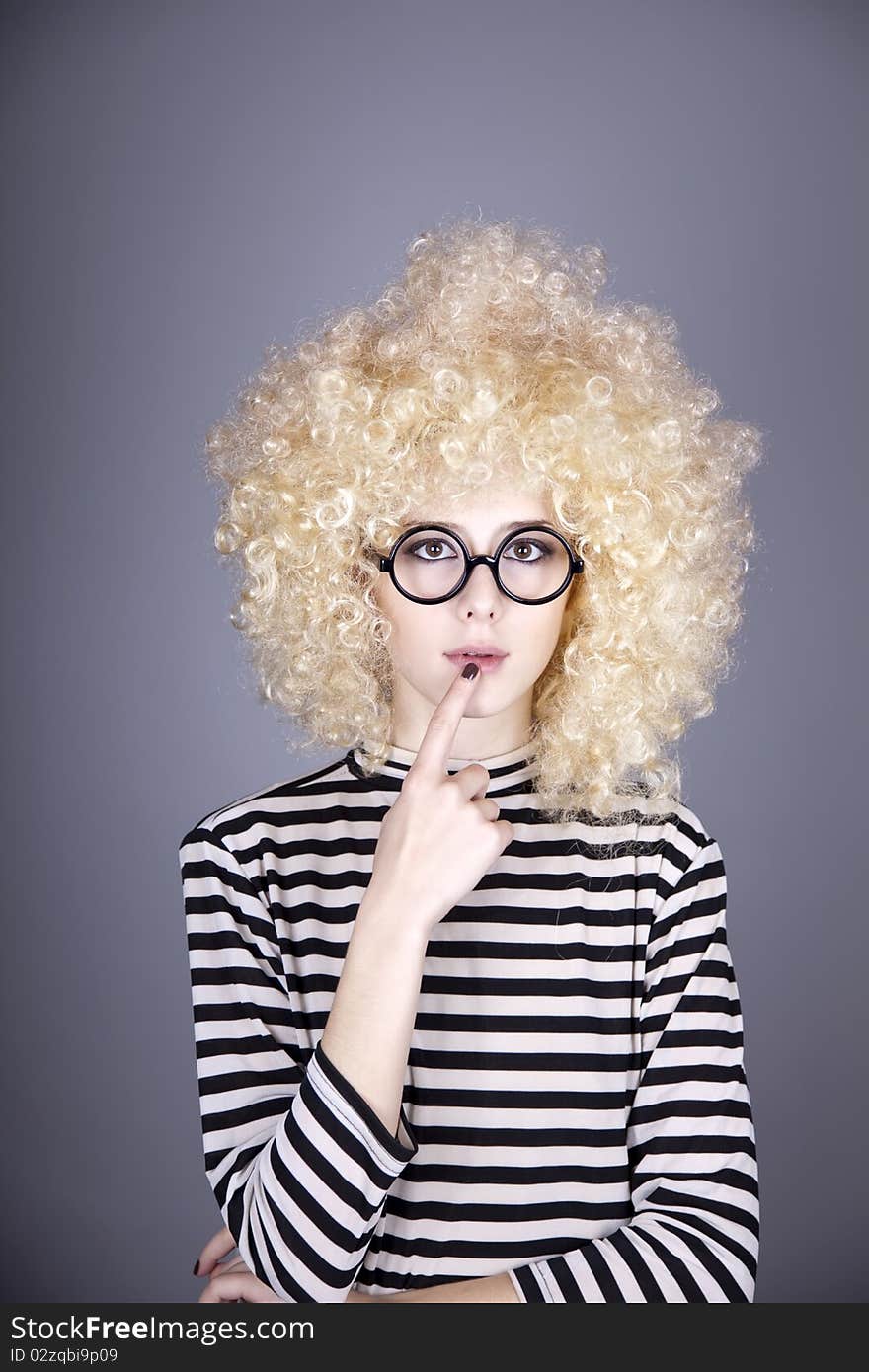 Portrait of funny girl in blonde wig. Studio shot.