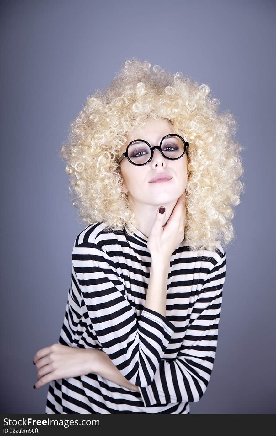 Portrait of funny girl in blonde wig. Studio shot.