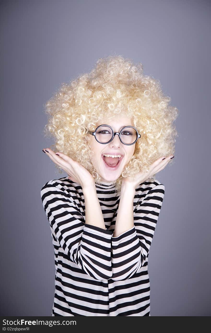 Portrait of funny girl in blonde wig. Studio shot.