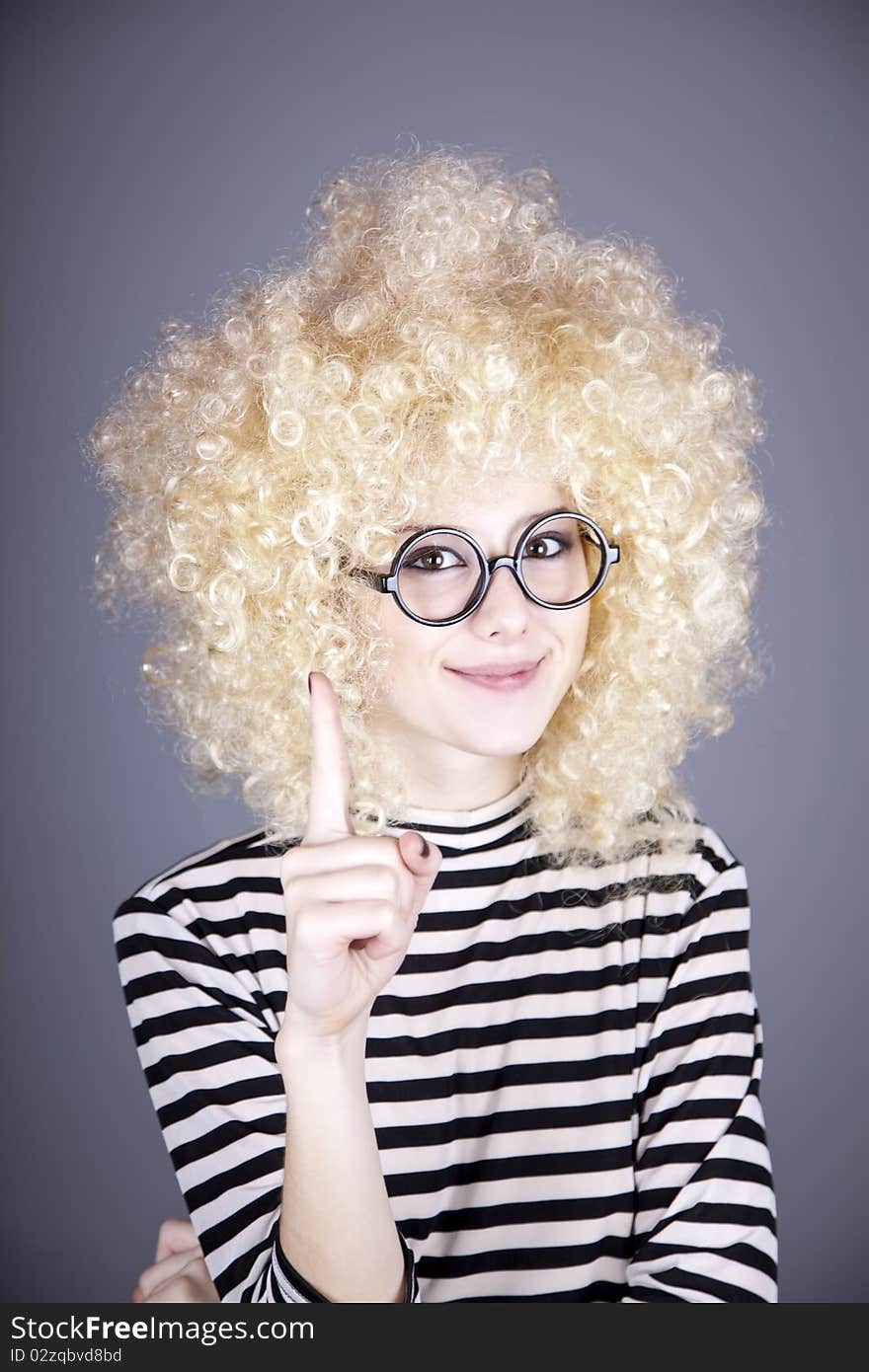 Portrait of funny girl in blonde wig.