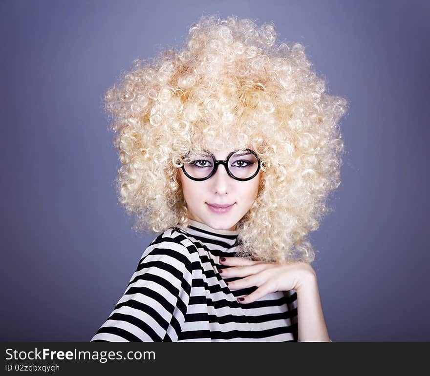 Portrait of funny girl in blonde wig. Studio shot.