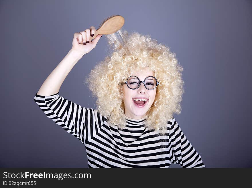 Surprised girl with comb. Studio shot.