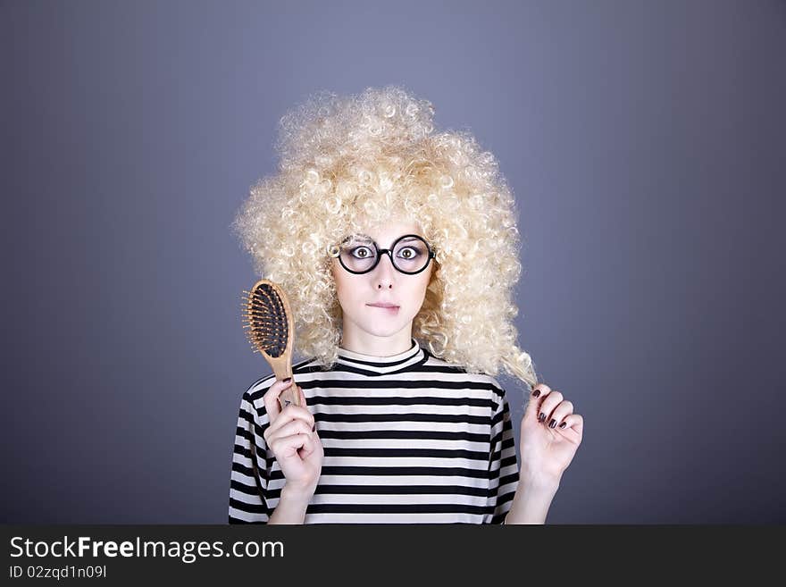 Surprised girl with comb. Studio shot.