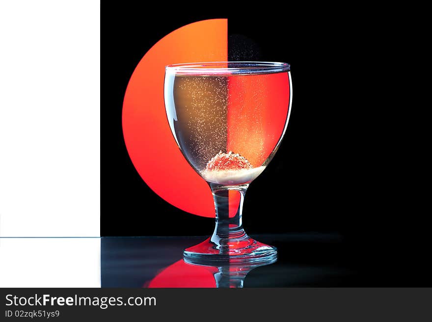 Glass goblet of wine, and berries on a colored background. Glass goblet of wine, and berries on a colored background.