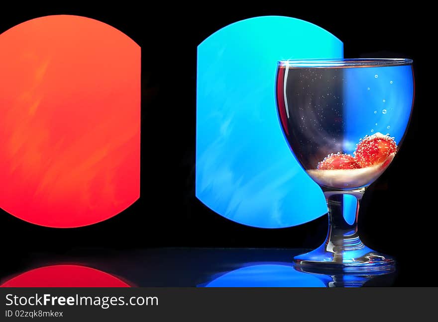 Glass wine goblet on a colored background.