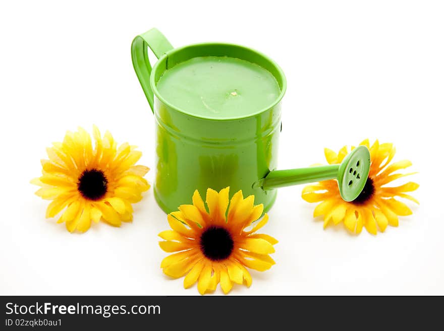 Green watering can with sunflowers