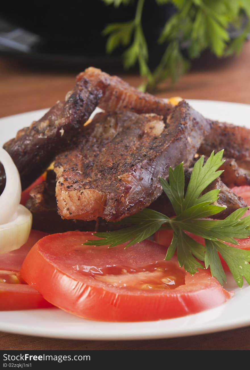 Pork steak with tomato close up