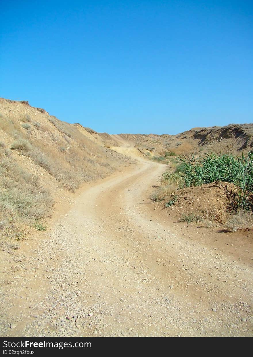 Deserted road in sandy hills. Black sea coastline. Deserted road in sandy hills. Black sea coastline.