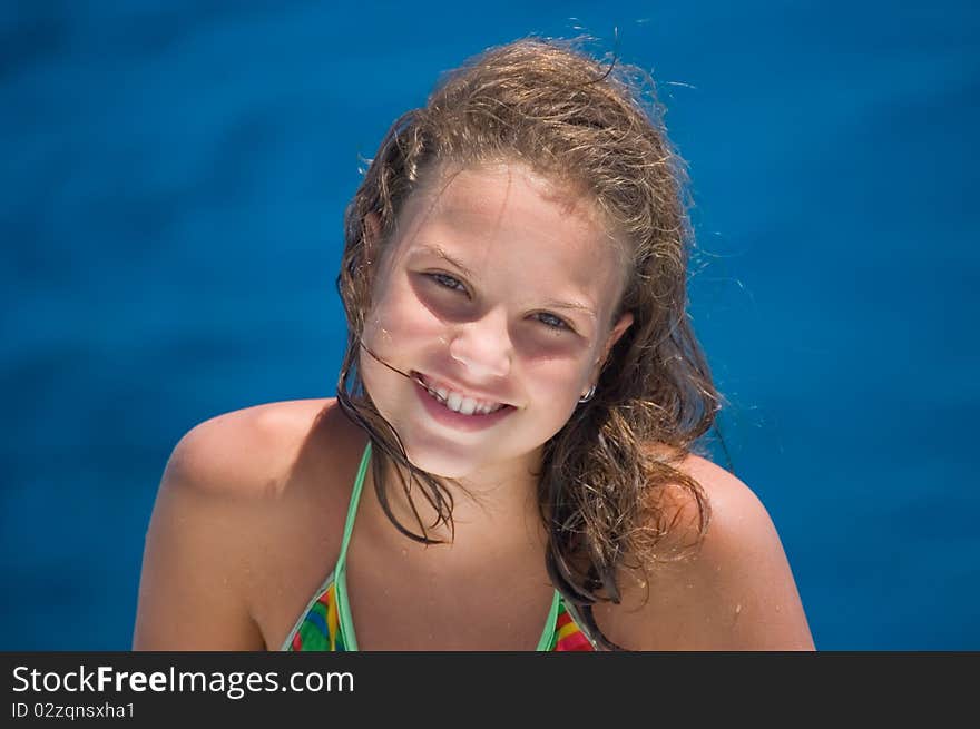 The happy girl against the sea close up