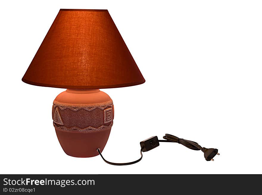 Red lamp with a shade on the isolated background