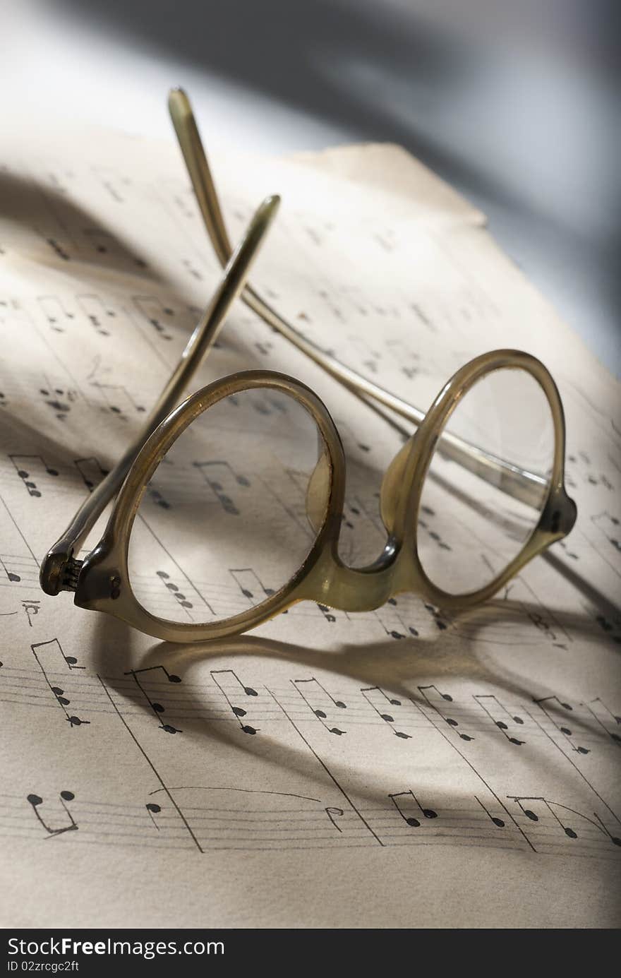 Glasses resting on a musical score