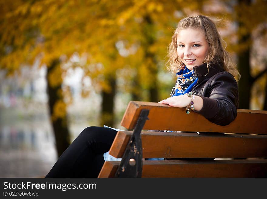 Young caucasian student girl in golden autumn park. Young caucasian student girl in golden autumn park