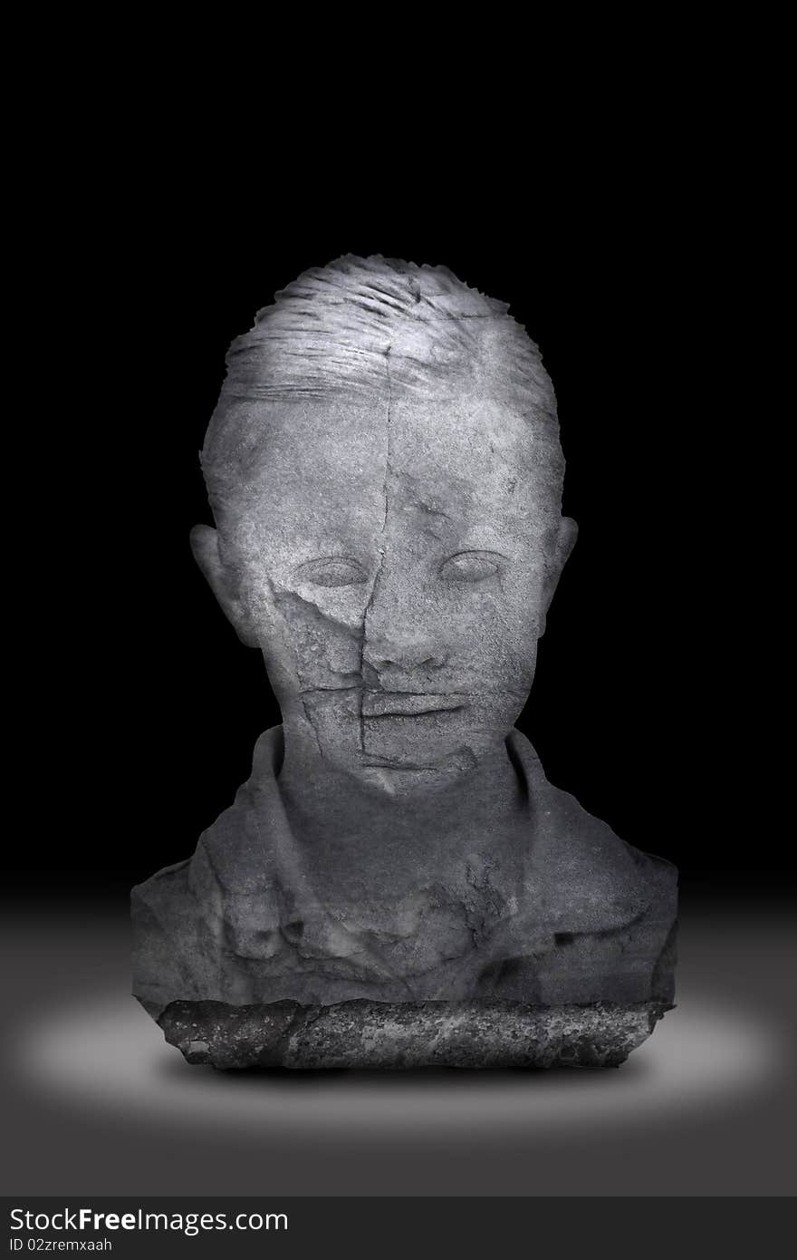 Stone bust of a child over black with spotlight.