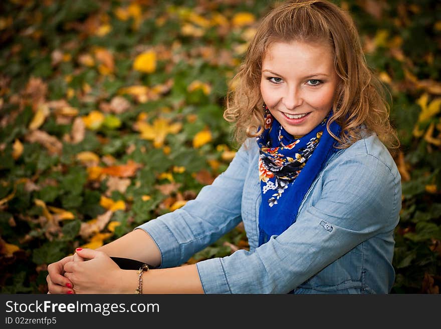 Young caucasian student girl in golden autumn park. Young caucasian student girl in golden autumn park