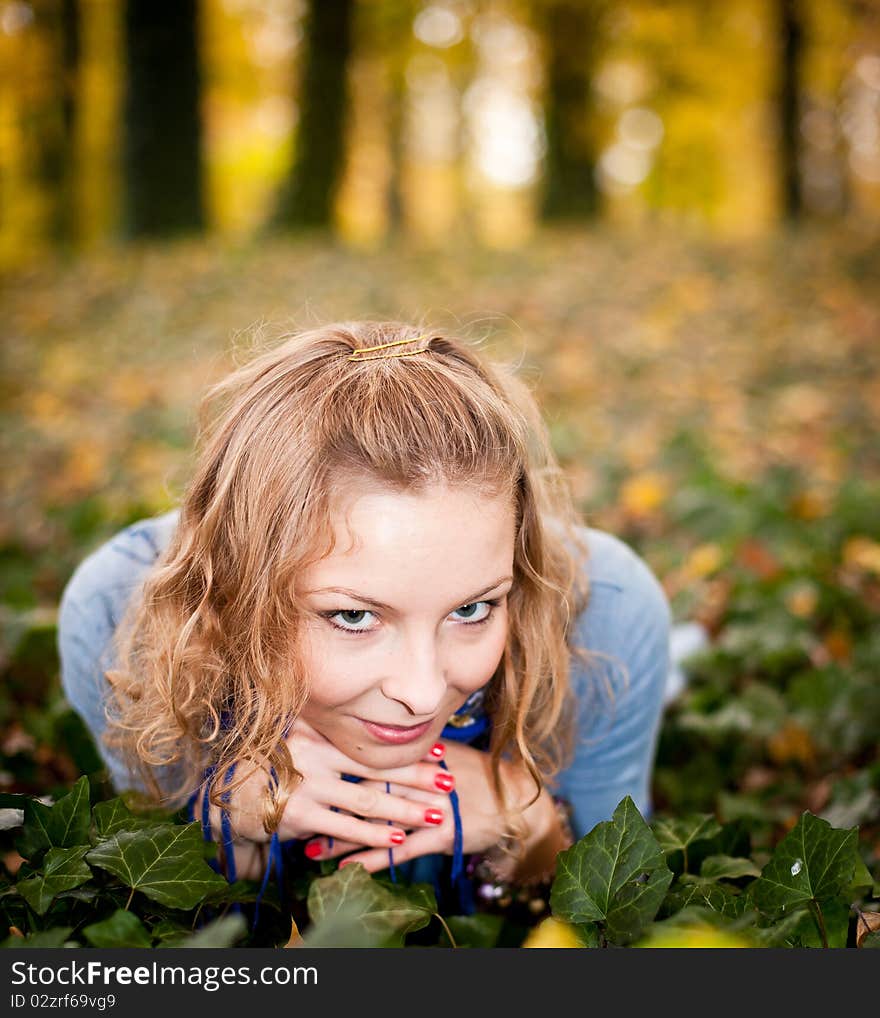 Young caucasian student girl in golden autumn park. Young caucasian student girl in golden autumn park