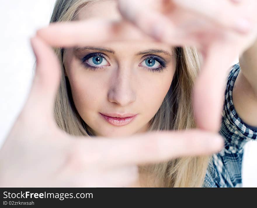 Young girl posing her hands like photo frame isolated on white. Young girl posing her hands like photo frame isolated on white