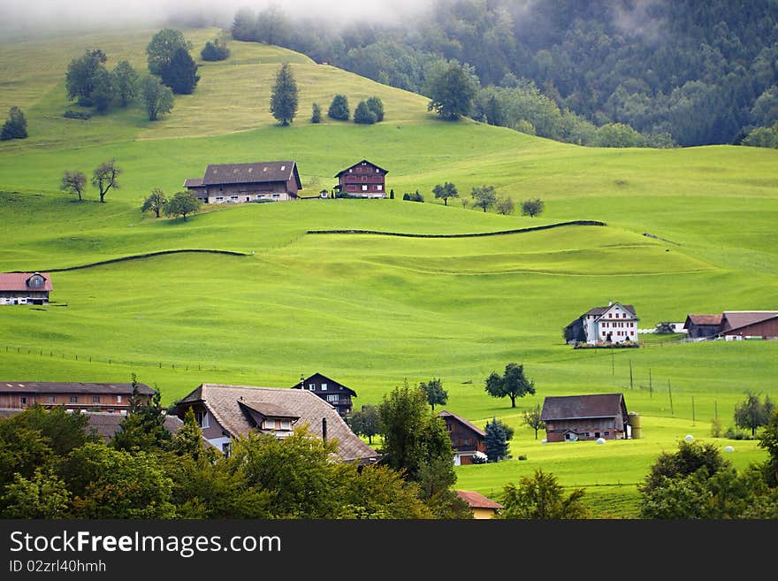 Few Cottages on the green grassy hill. Few Cottages on the green grassy hill