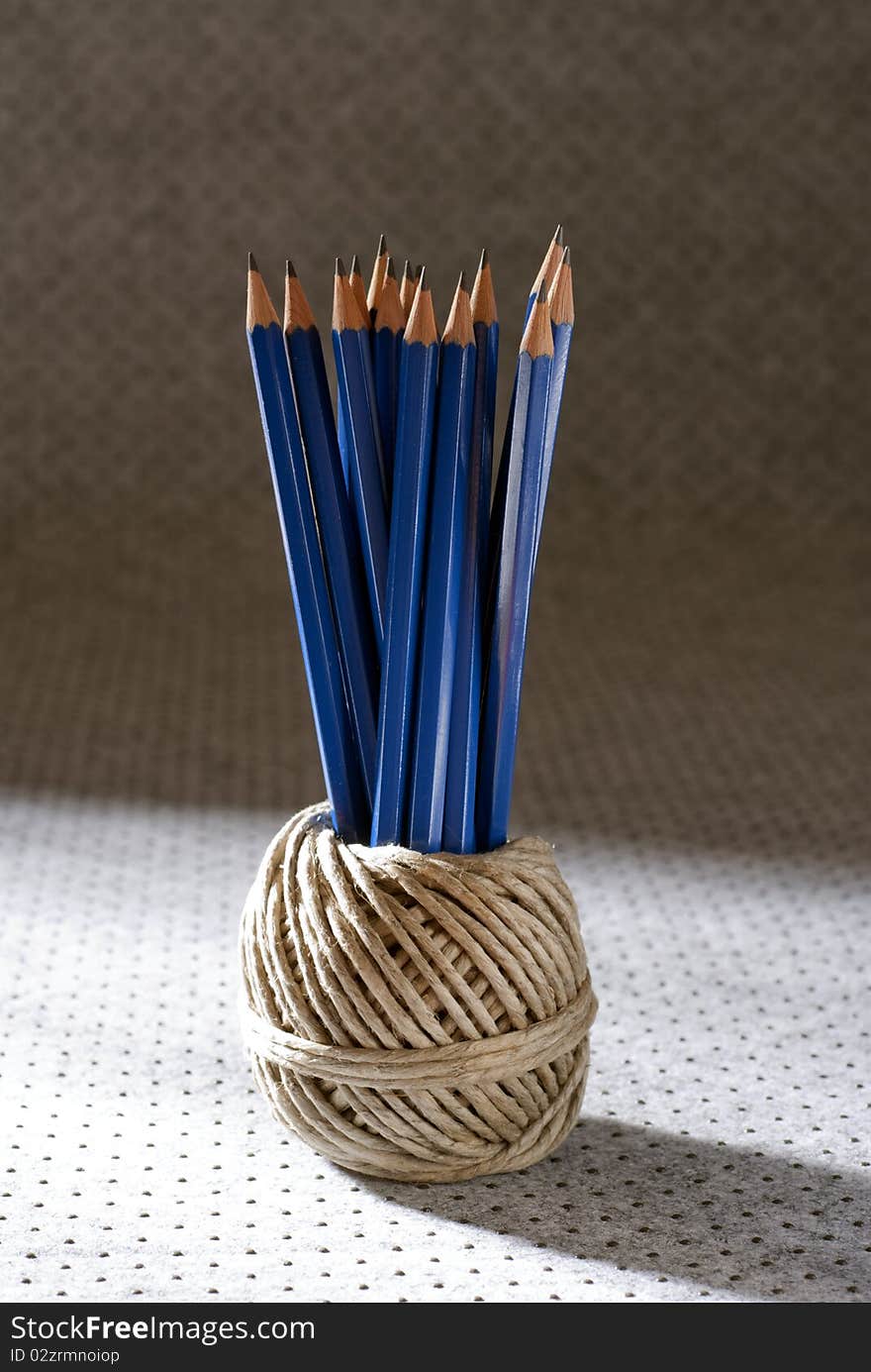 Bunch of pencils placed in a ball of twine