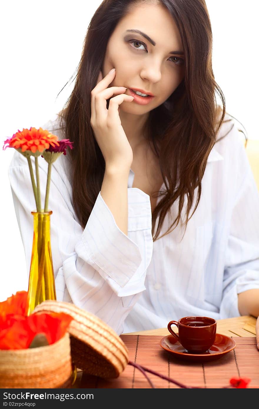 Beautiful woman in cafe over white background with red flowers. Beautiful woman in cafe over white background with red flowers