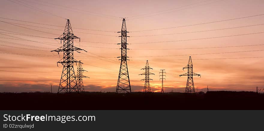 Electricity Pylons And Lines At Dusk.