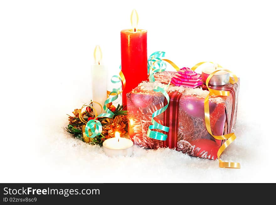 Christmas gifts with candles, snow and ribbons on white background. Christmas gifts with candles, snow and ribbons on white background