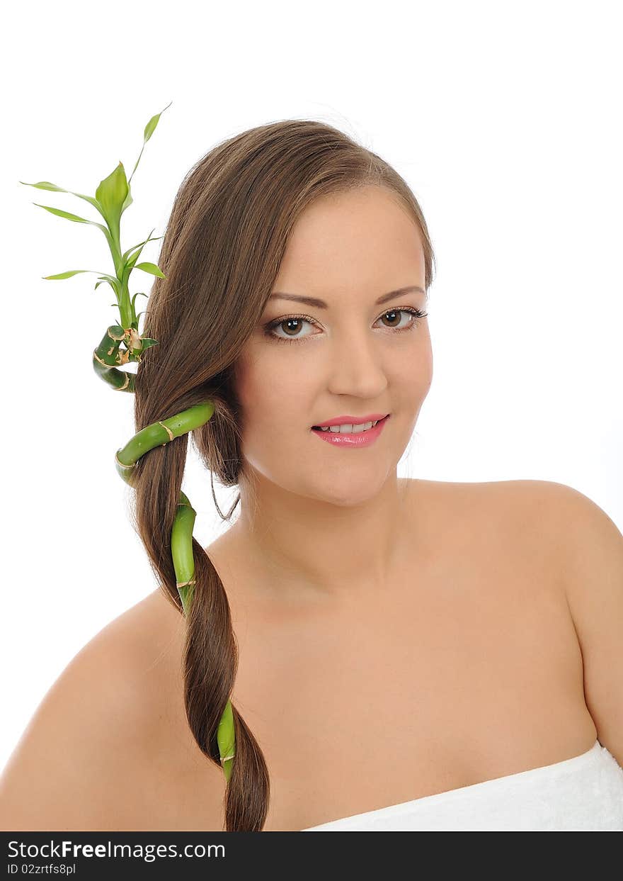 Beautiful happy spa woman with long healthy hair and pure skin with a bamboo. isolated on white background