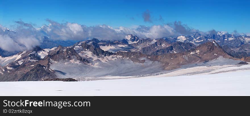 Panorama snow declivity and array of the mountains