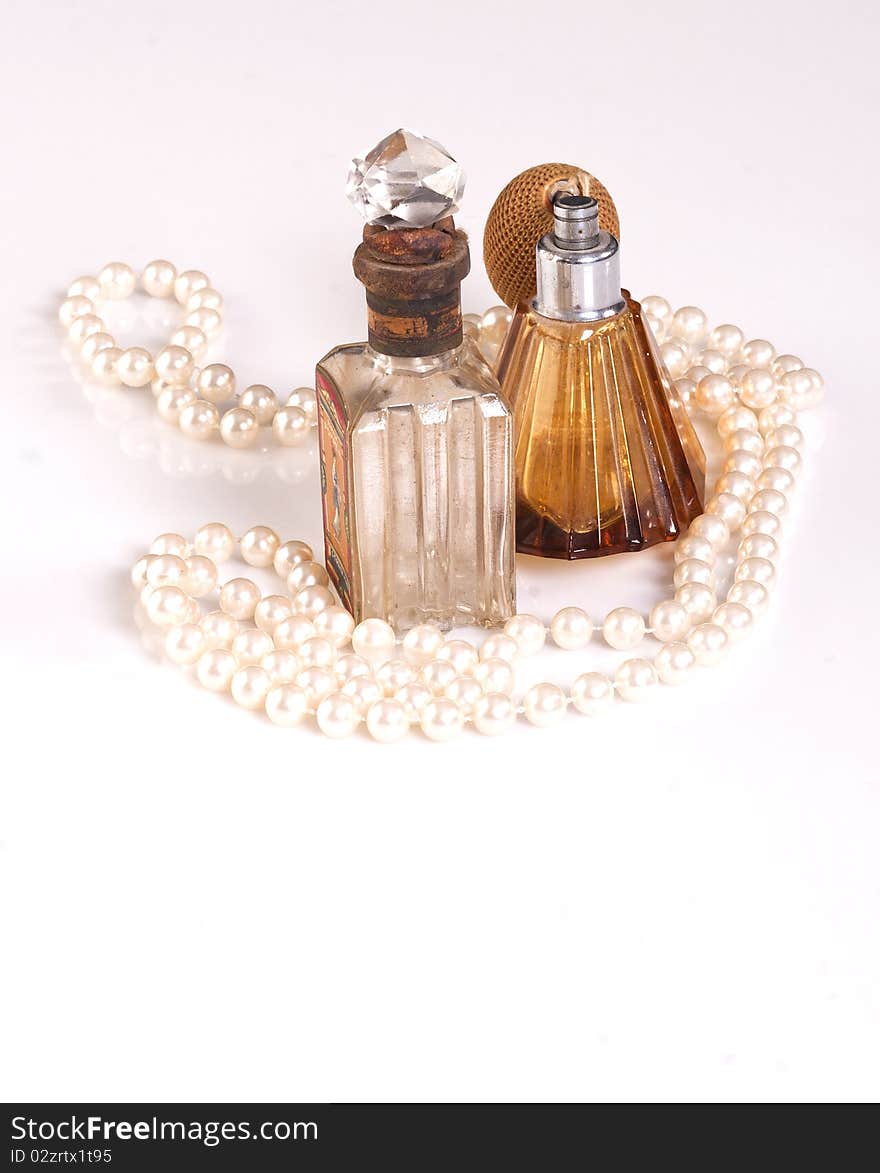 TWO PERFUME BOTTLES AND PEARLS