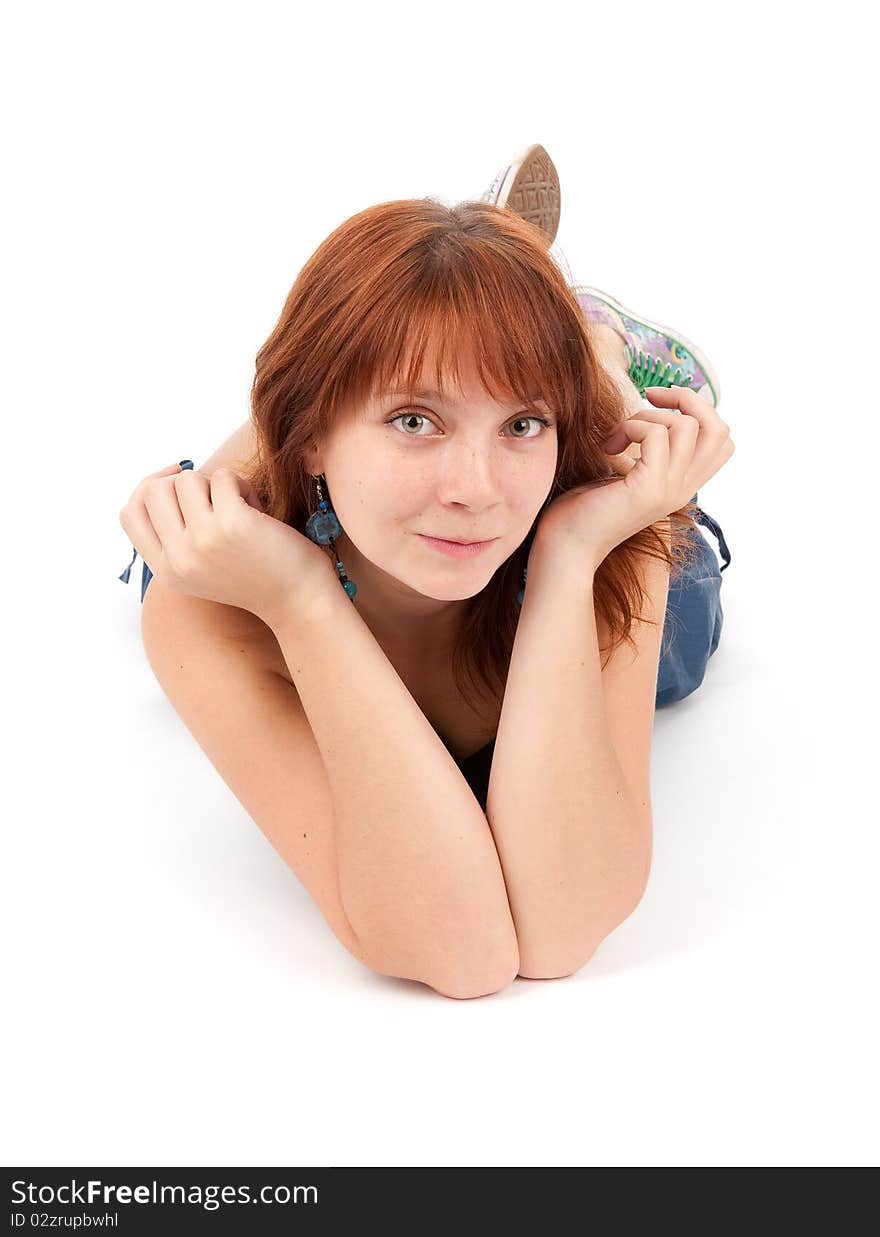 Portrait of a smiling young woman lying on the floor isolated on white background