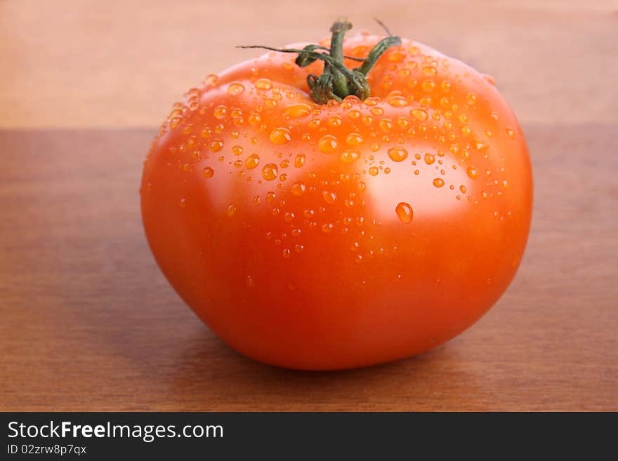 Close up tomato isolated on wood texture background