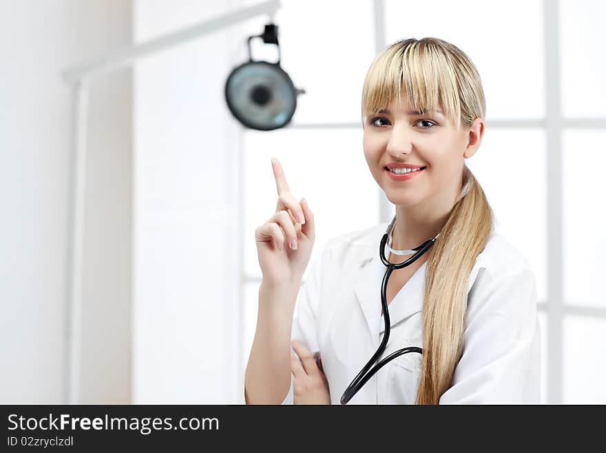 Beautiful woman doctor in uniform in cabinet