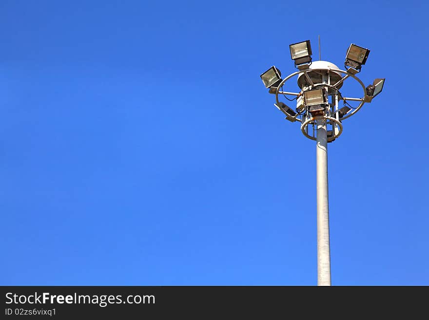 Spotlights post isolated on sunny blue sky