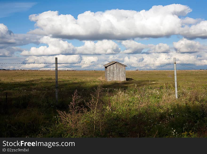 The small house stands up for a fence from a barbed wire