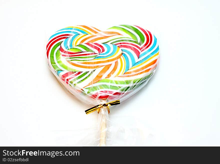 Close up of colourful lollipop, heart shape.