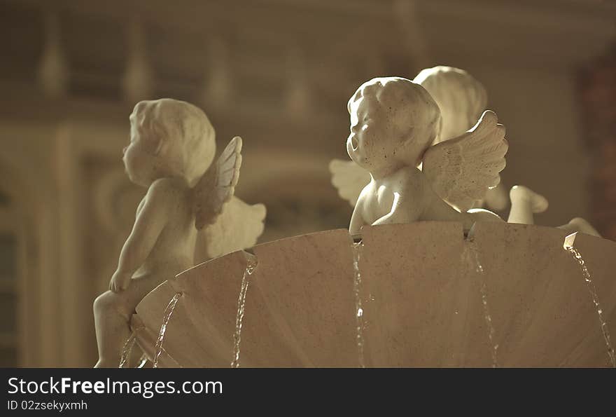 White color cupid statues on fountain. White color cupid statues on fountain